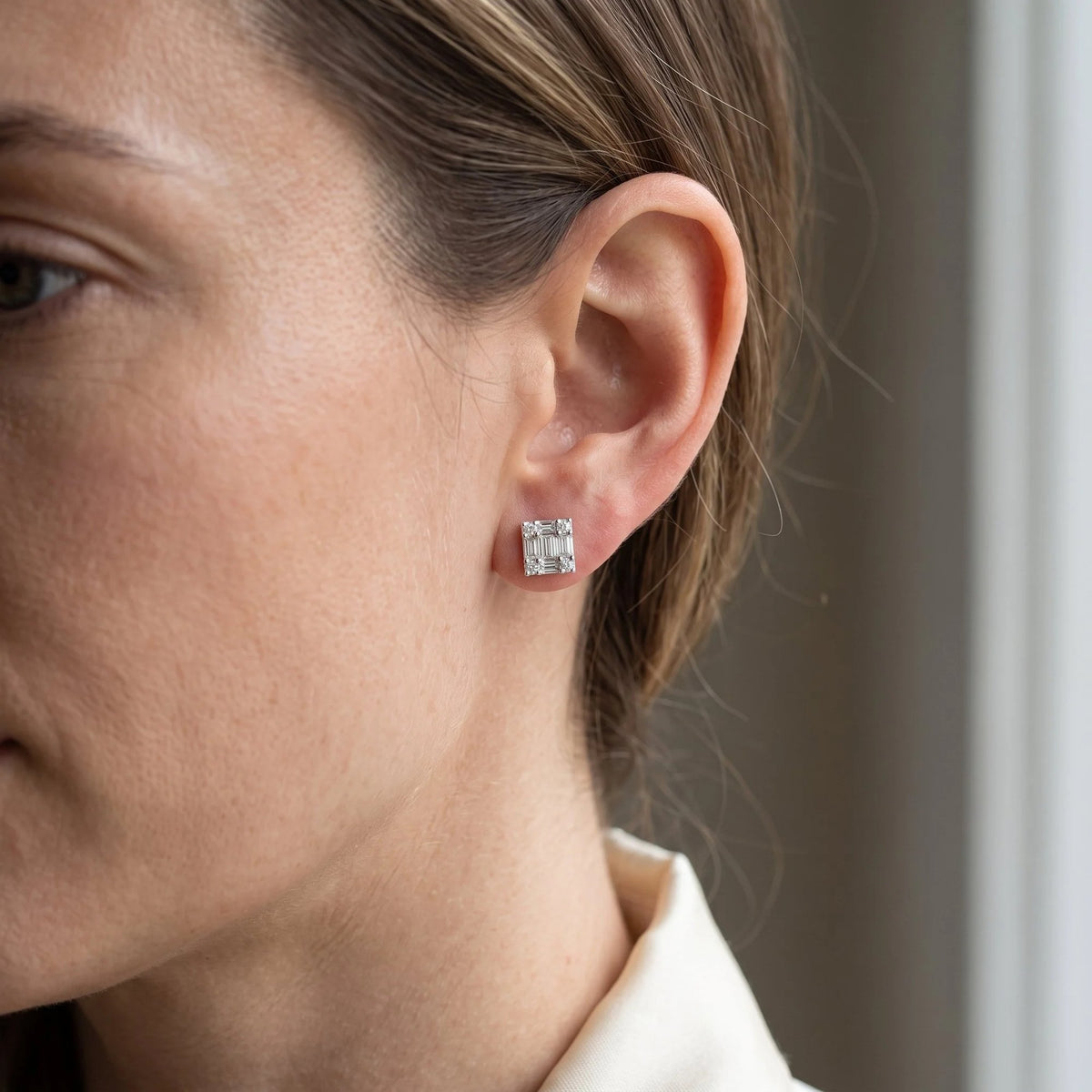 18k white gold baguette diamond stud earring worn on the ear
