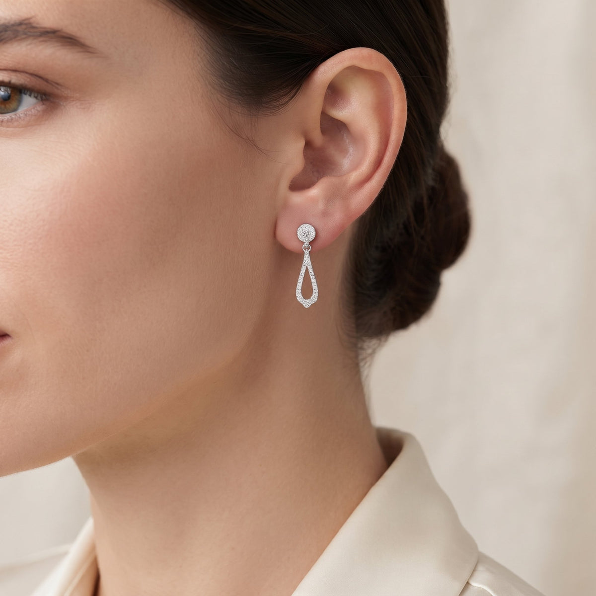 18k white gold diamond cluster drop earring worn on the ear