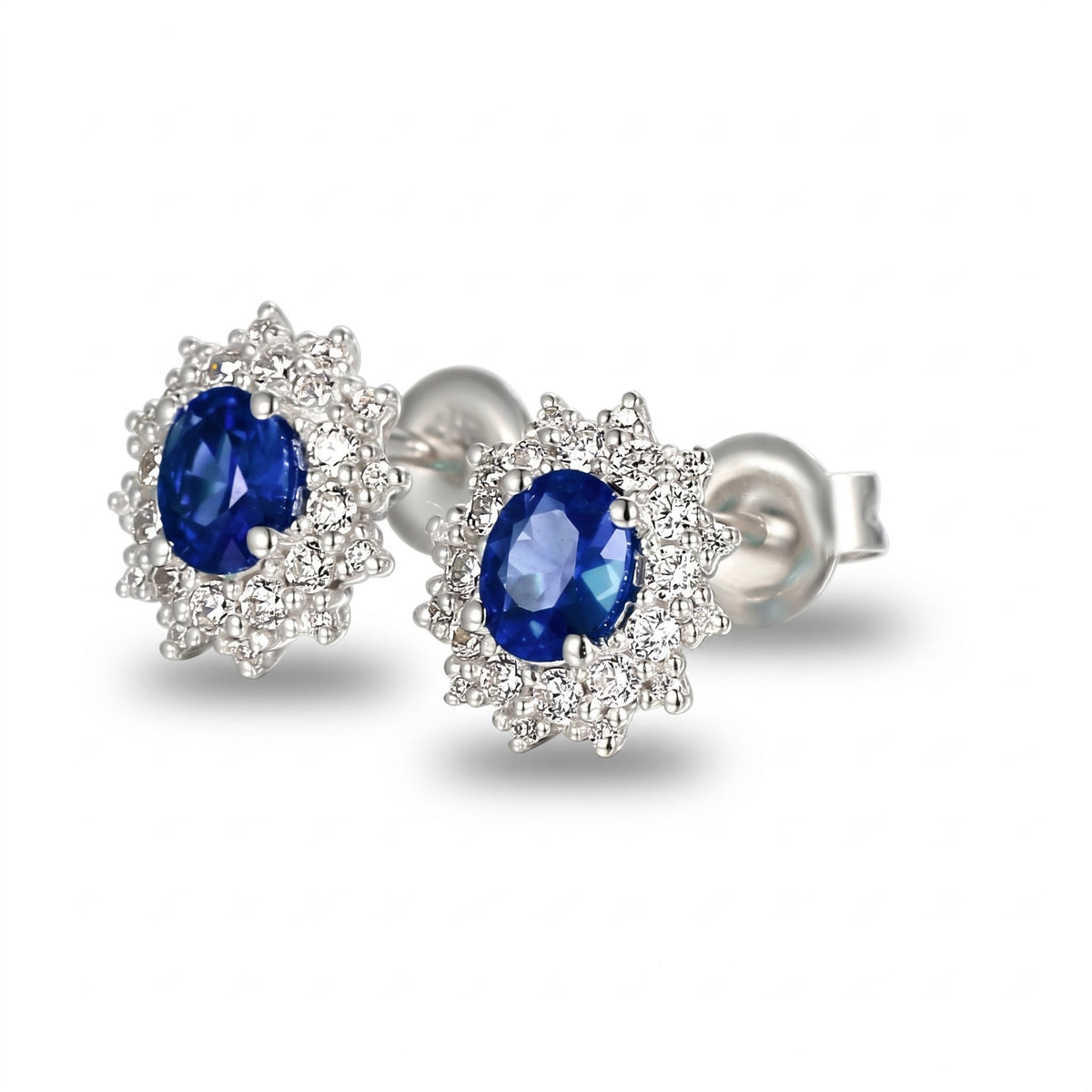 Oval sapphire and diamond cluster earrings in 18k white gold