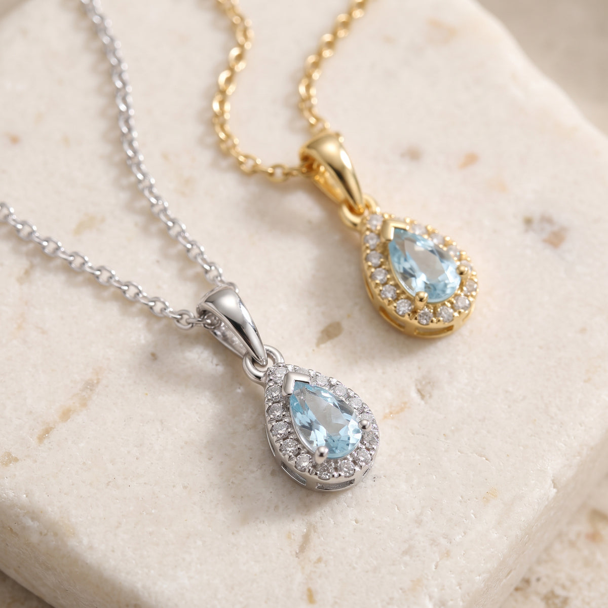 Pear aquamarine and diamond halo pendants in 18k white and yellow gold