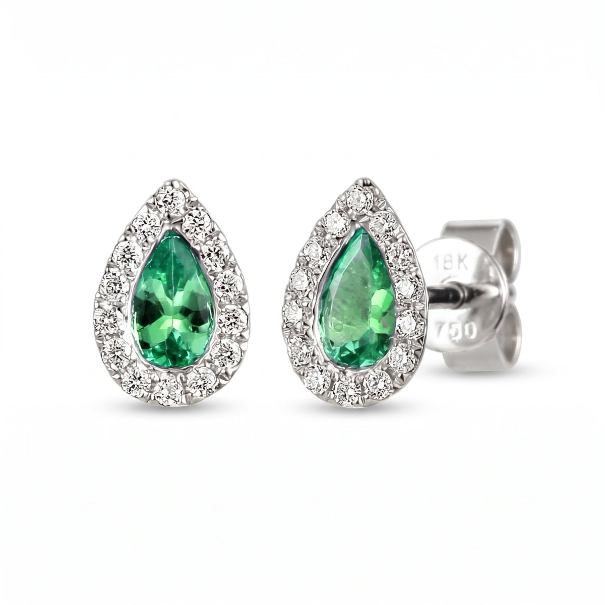 Pear emerald and diamond rubover halo earrings in 18k white gold