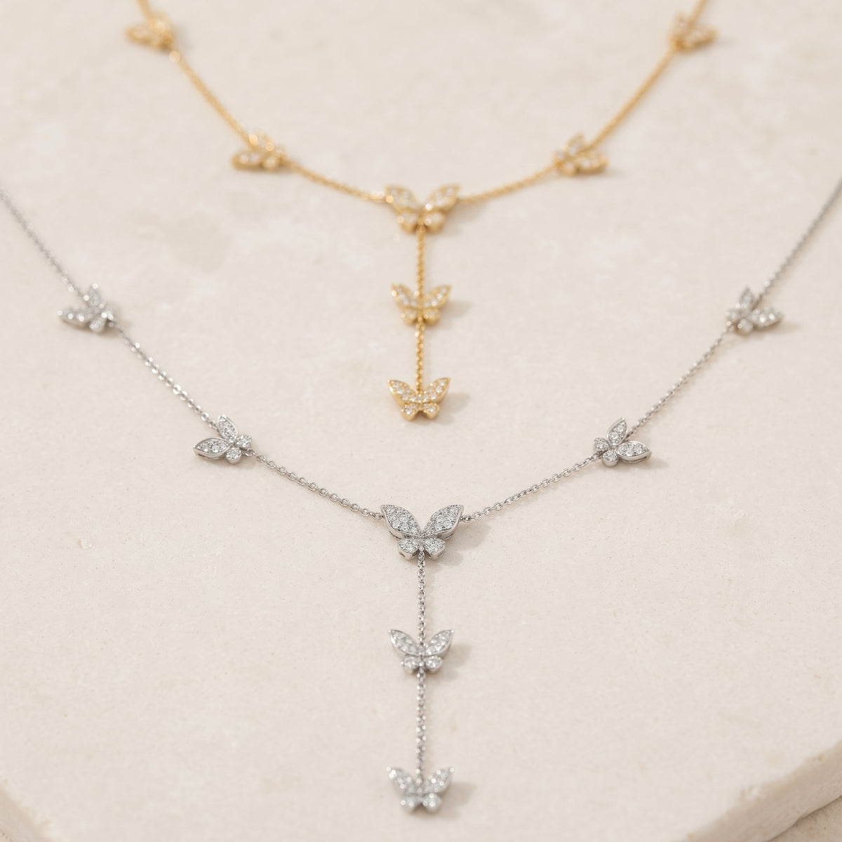 Diamond by the yard butterfly necklaces in 18k white gold and 18k yellow gold