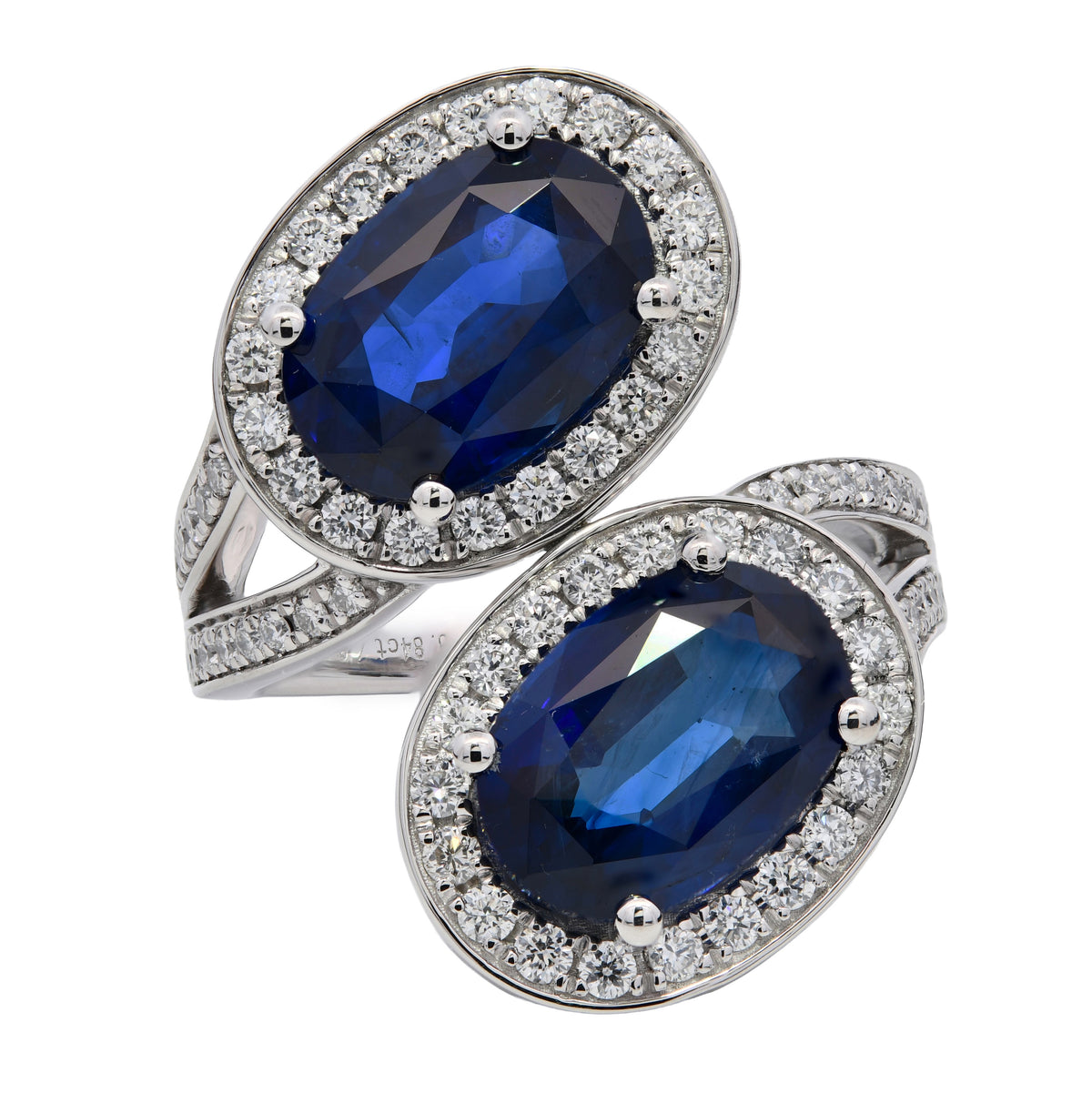 Blue sapphire and diamond crossover ring in platinum
