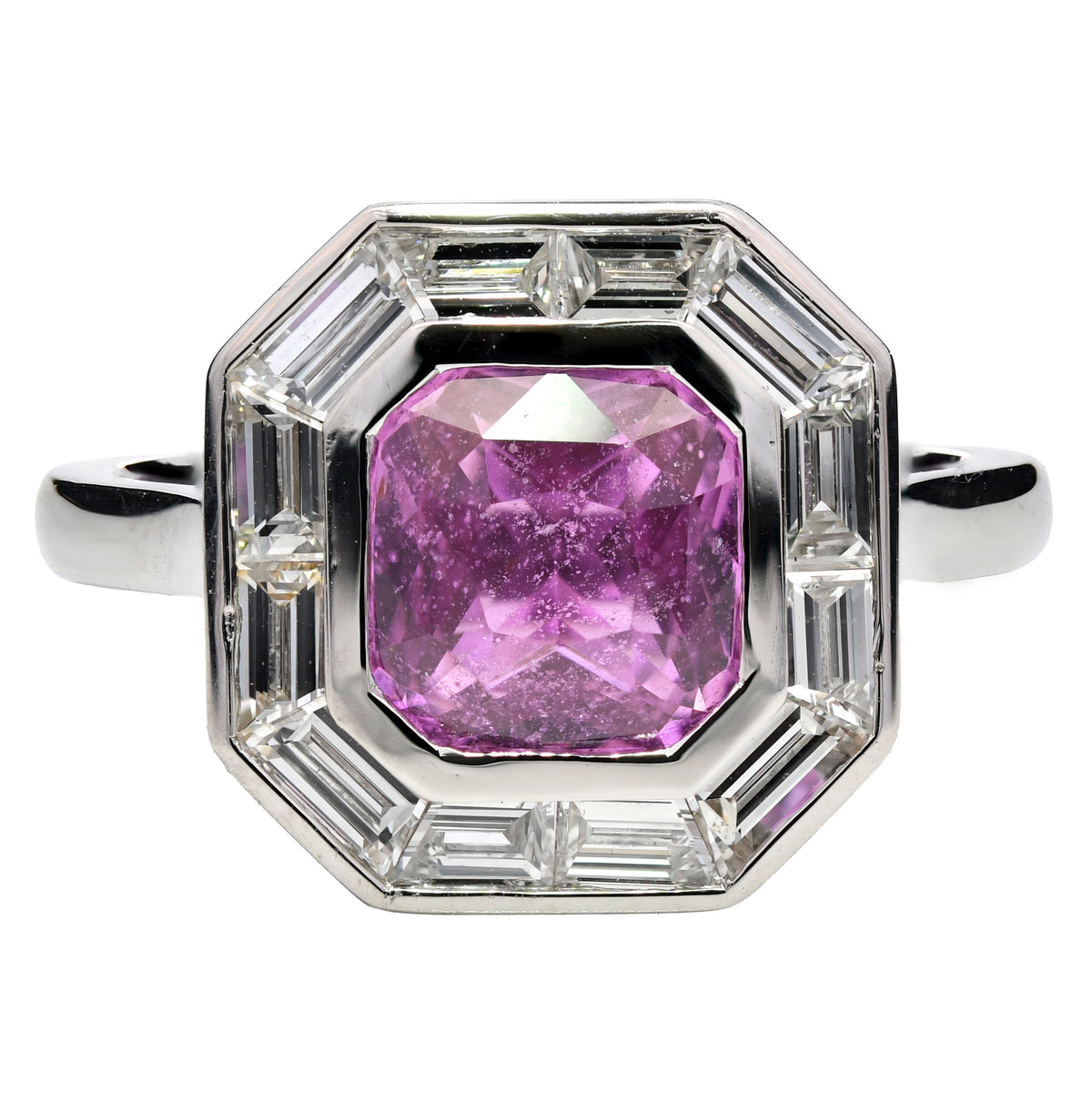 Pink sapphire and diamond halo ring in platinum