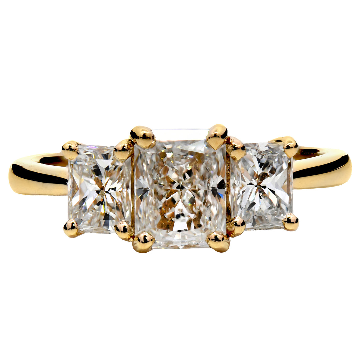 Radiant cut diamond three stone ring in 18k yellow gold
