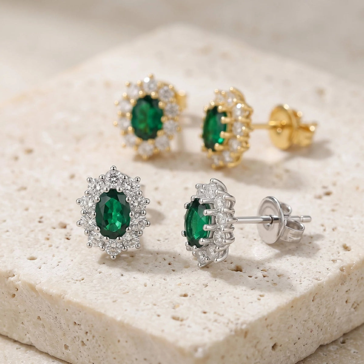 18k white gold oval emerald and diamond cluster earring worn on the ear