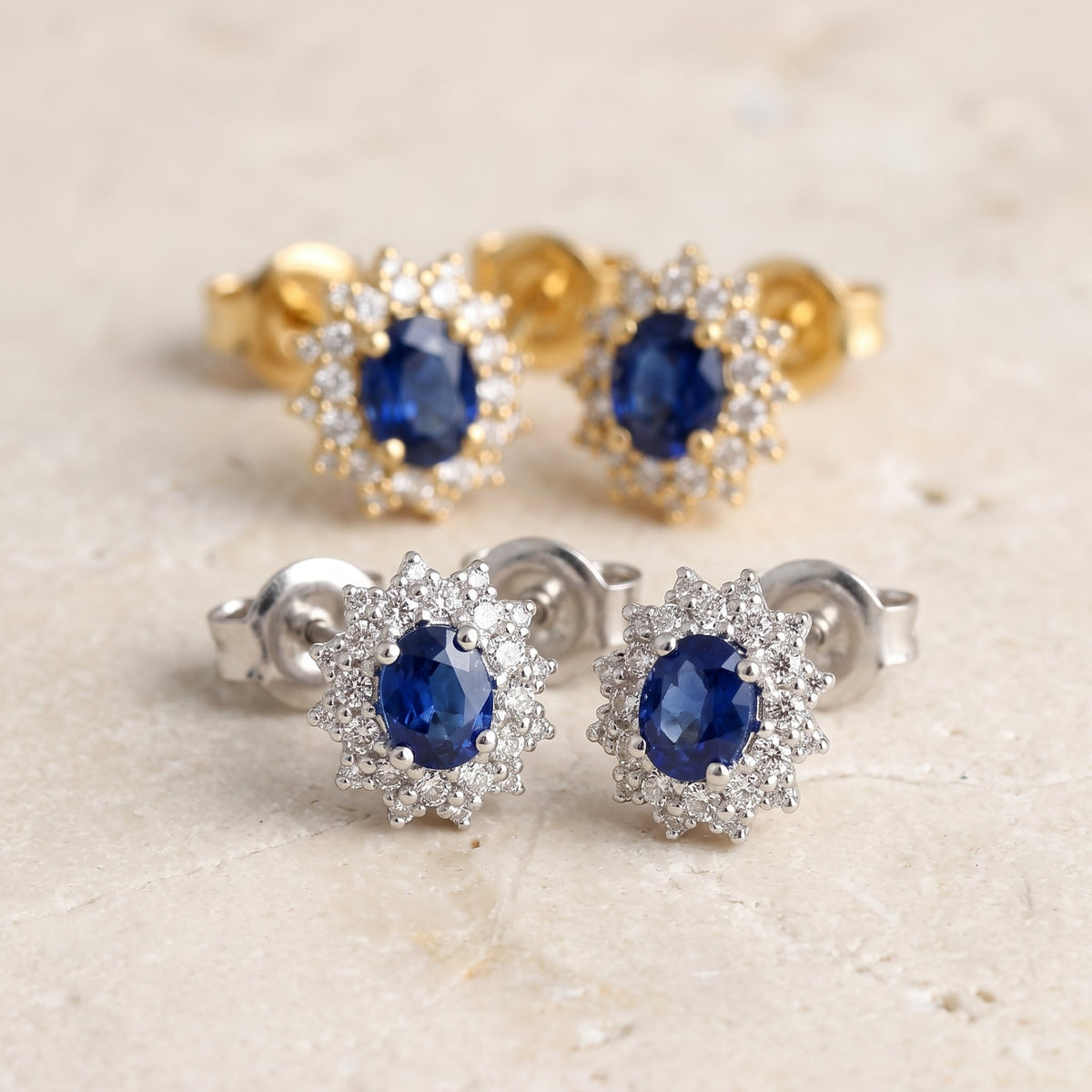 Oval sapphire and diamond cluster earrings in 18k white and yellow gold