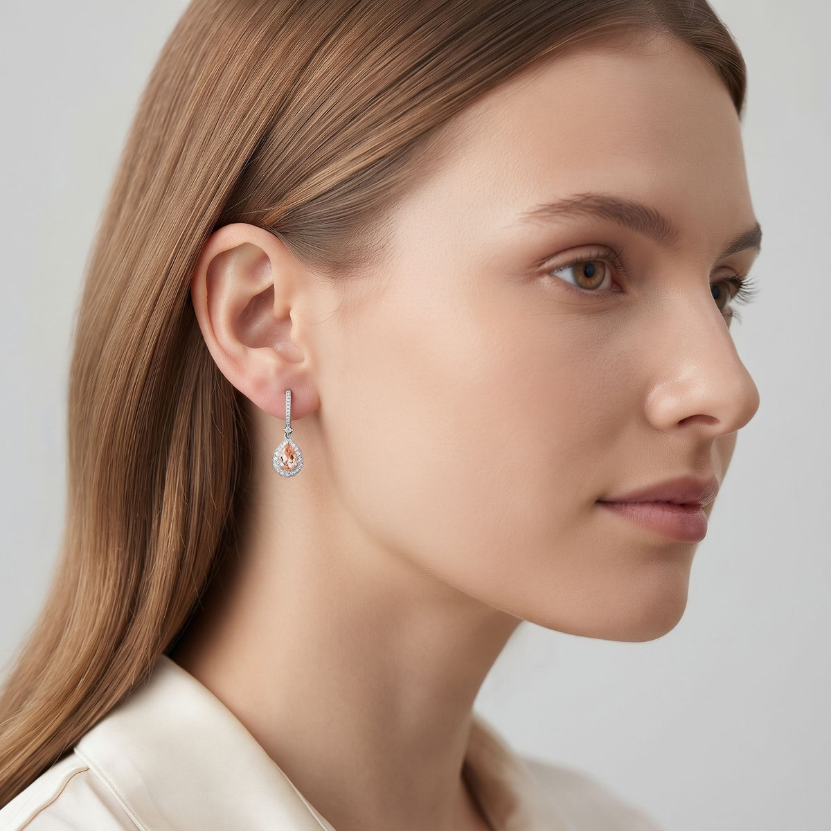 18k white gold pear morganite and diamond drop earring worn on the ear