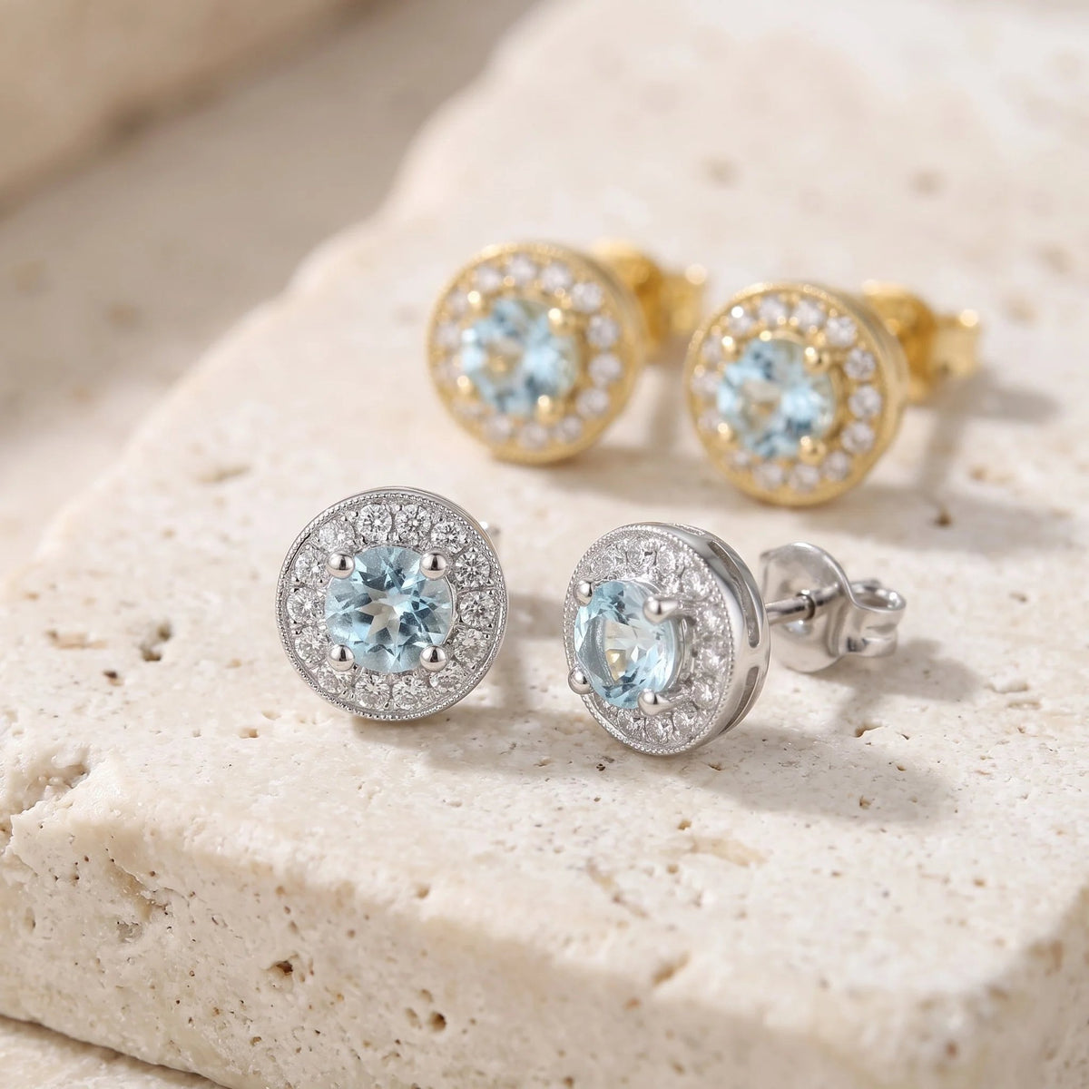 Round aquamarine and diamond milgrain halo earrings in 18k white and yellow gold